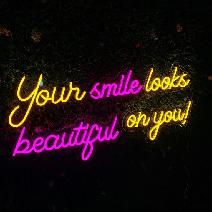 SELICOR neon art wall decor featuring Your Smile Looks Beauty On You! in vibrant glowing script against a contrasting backdrop