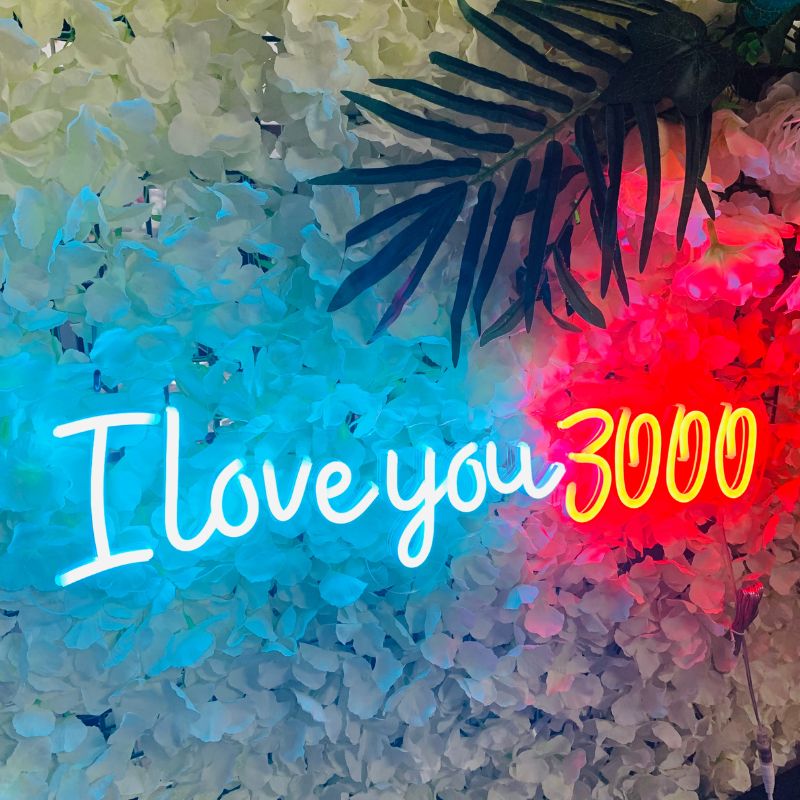  A glowing SELICOR wedding sign displaying I Love You 3000 in captivating script against a dark backdrop