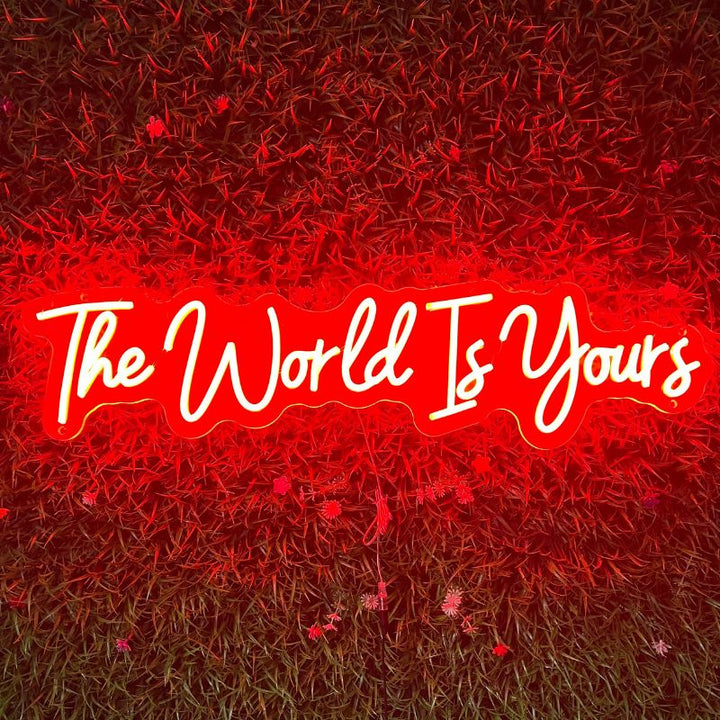 A SELICOR neon artwork showcasing the encouraging statement The World is Yours in a spectrum of vivid radiant colors