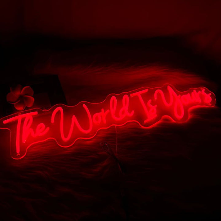 A visually captivating SELICOR neon sign with the words The World is Yours glowing in brilliant colors creating a captivating ambiance