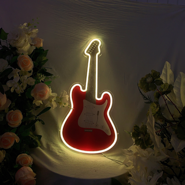 Luminous RGB guitar-shaped neon sign emitting multi-colored lights.