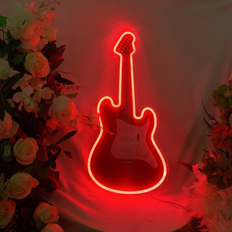 Vibrant RGB-changing neon guitar sign illuminating in dynamic colors.