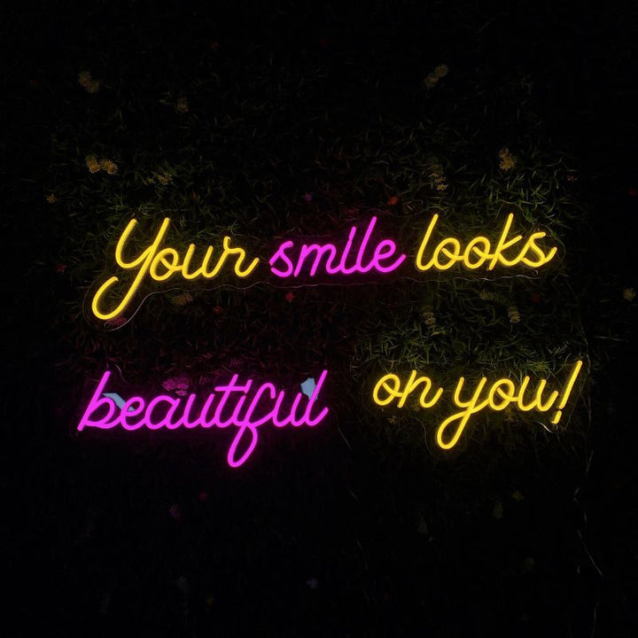 NEON wall decor from SELICOR with the inspiring message Your Smile Looks Beauty On You! in mesmerizing glowing letters enhancing room aesthetics